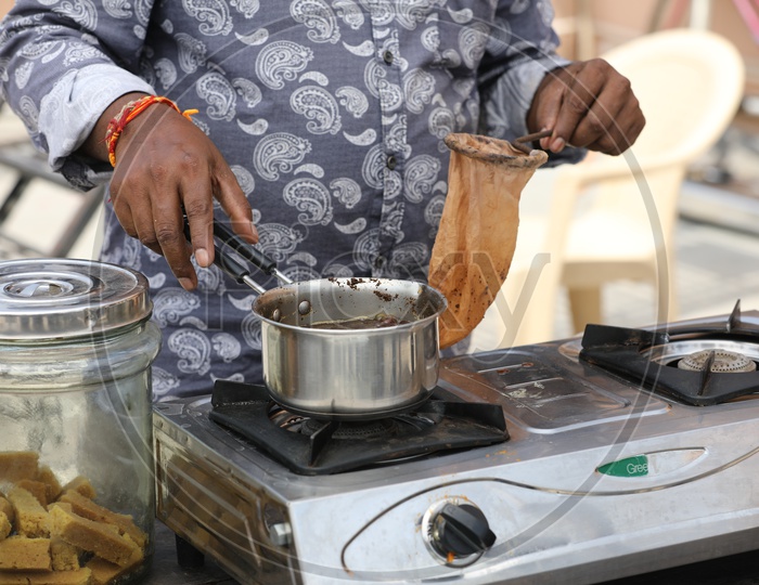 Vendor Preparing Tea Or Chai In a Vendor Stall