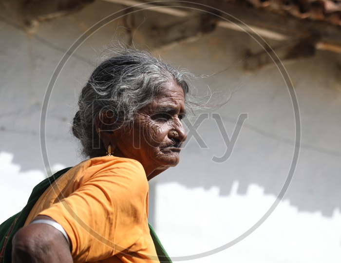 An Old Woman  of a Rural Village  at Her House Premise