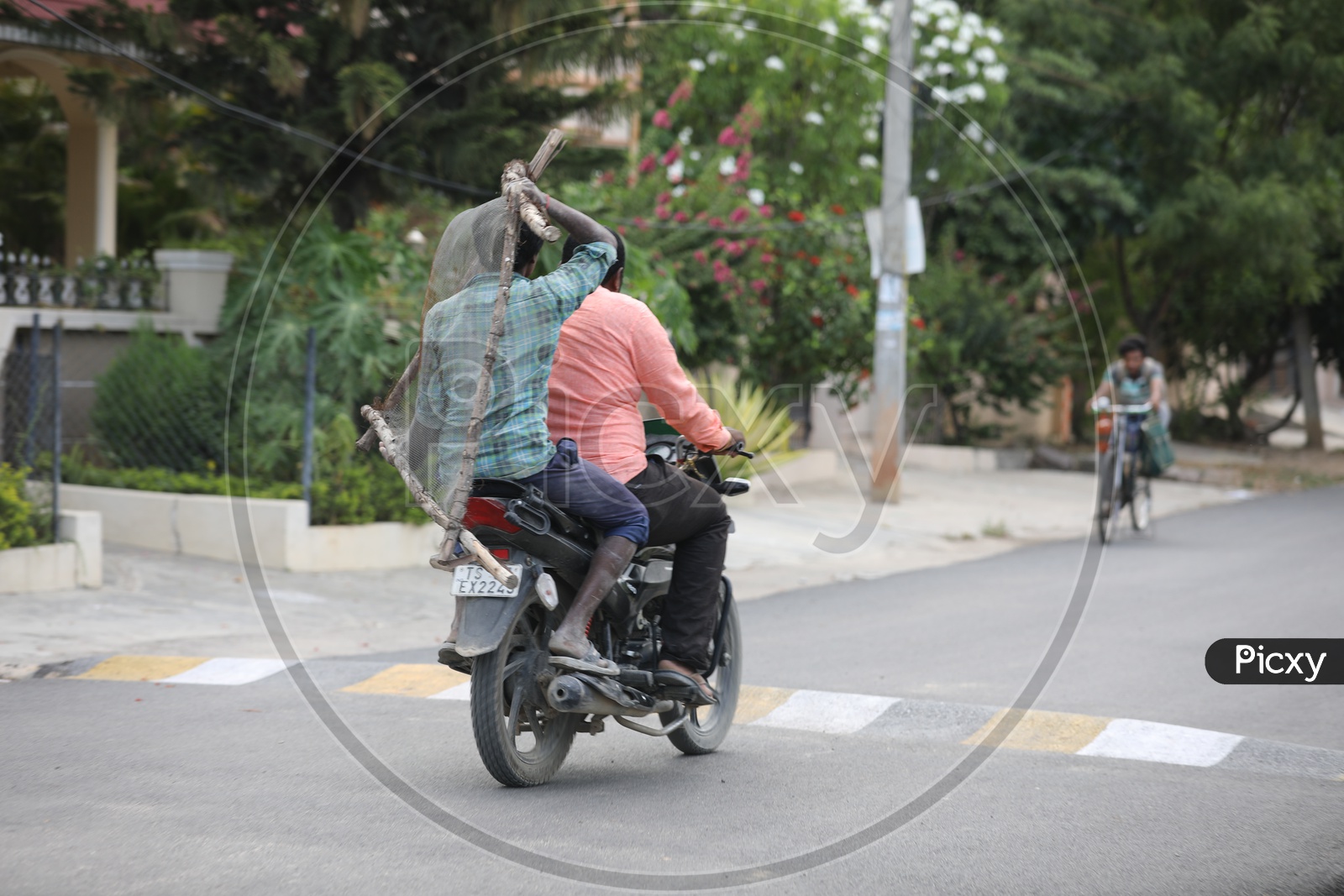 Daily Workers Of Construction Site Carrying Sieve Mesh in a Bike