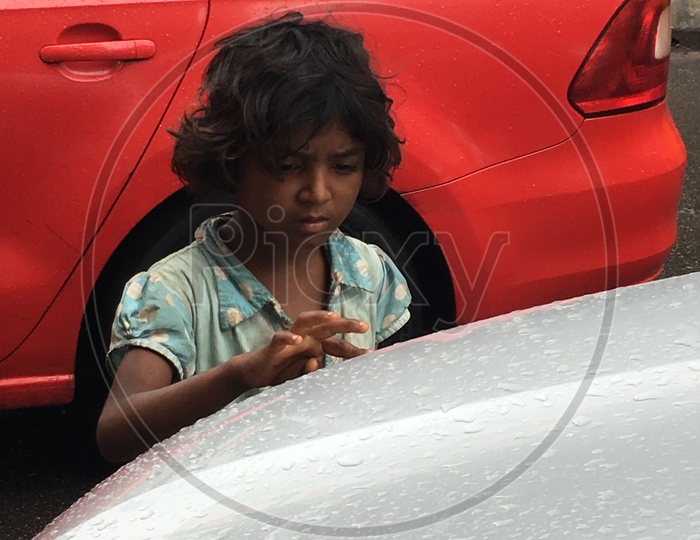 Girl Playing With Rain Droplets on a Car bannot
