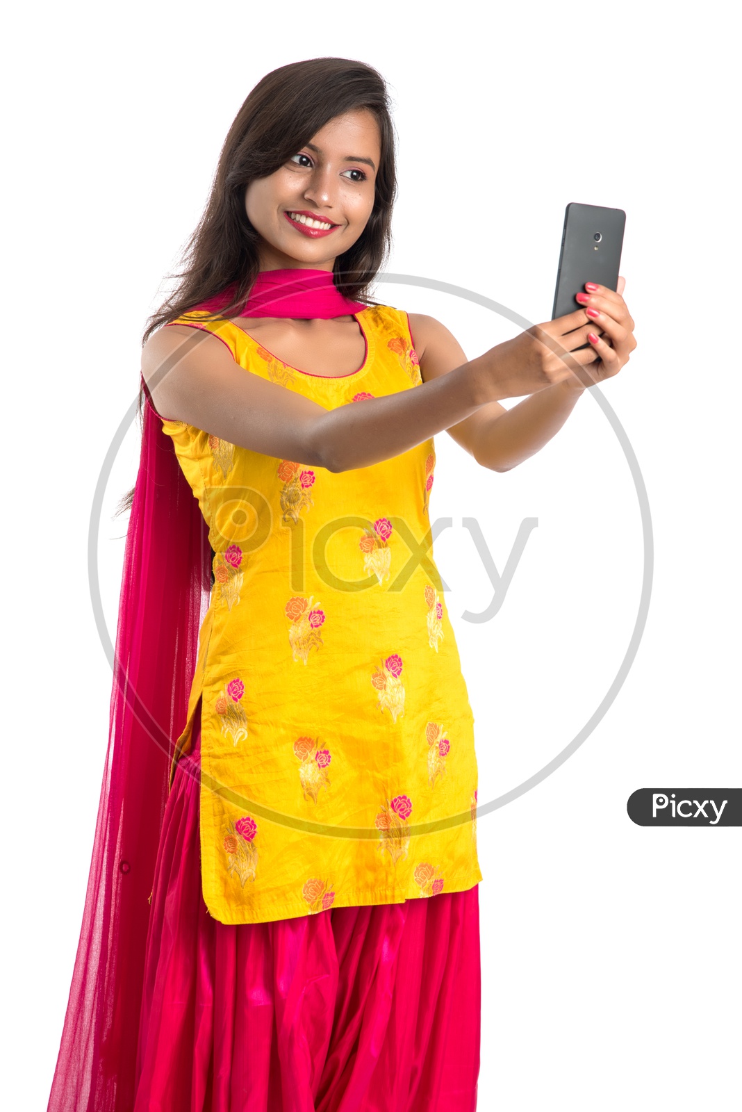 Young Indian Girl or Woman Taking Selfie With a Smartphone  On an Isolated White Background