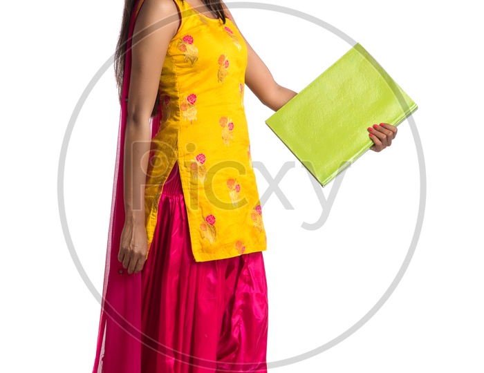 Young Indian Girl Student Holding Books In Hand And Posing On an Isolated White Background