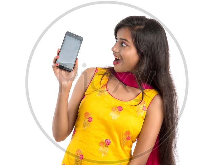Young Indian Girl or Woman Showing   Smartphone  or Mobile Empty Screen With an Expression On an Isolated White Background