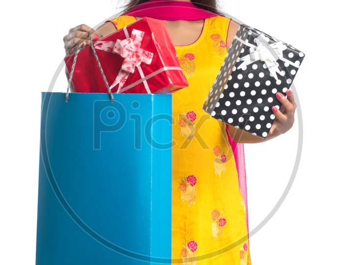 Young Indian Woman Or Girl Happily Smiling With Shopping Bags Gifts  On an Isolated White background