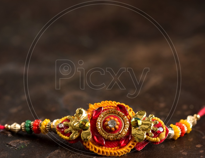 Elegant Rakhi  On an Textures Background For Raksha Bandhan Festival