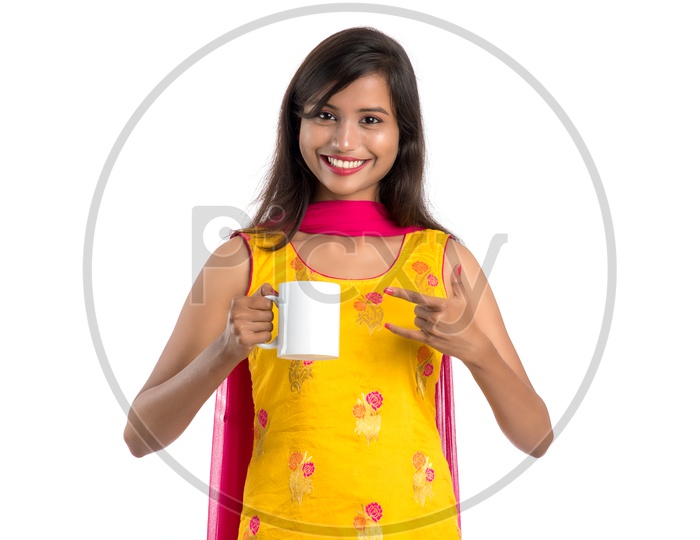 Young Indian Woman or Girl Holding or Drinking  coffee  in a Cup And Posing on an Isolated White Background