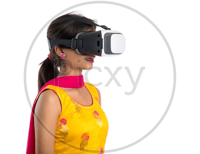 Young Woman Or Indian Woman Wearing  VR Headset or Virtual Reality Glasses On an Isolated white Background