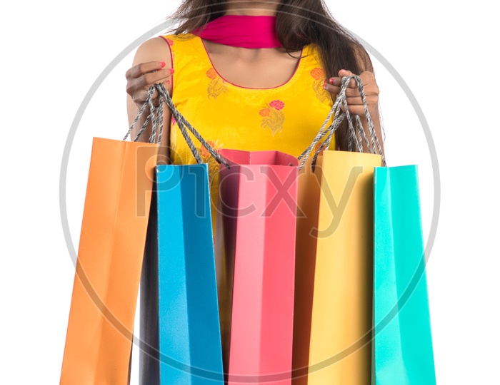 Young Indian Woman Or Girl Happily Smiling With Shopping Bags On an Isolated White background