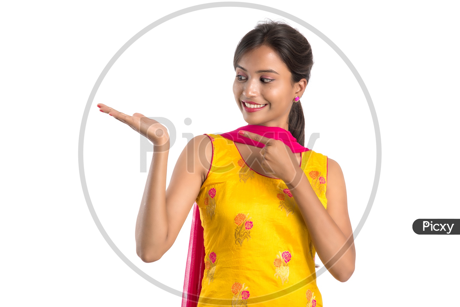 Young Indian Girl Or Woman Smiling Happily And Showing Space  On an Isolated White Background