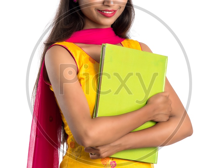 Young Indian Girl Student  Holding Books And Posing  On an Isolated White Background