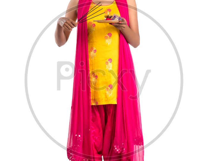 Young Indian Girl Or Woman Or Sister Holding Rakhi  And Pooja Thali Or Plate  With Expressions On an Isolated White Background