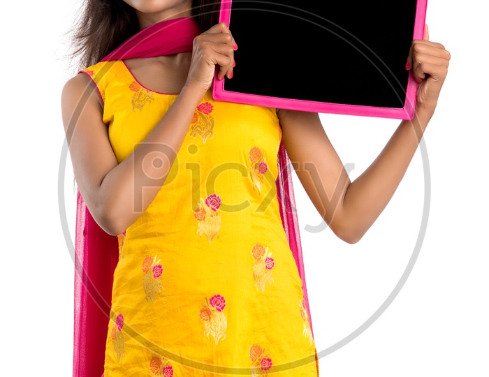Young Indian Woman or Girl Holding and  Showing an Slate With empty Space With an Expression On an Isolated White Background