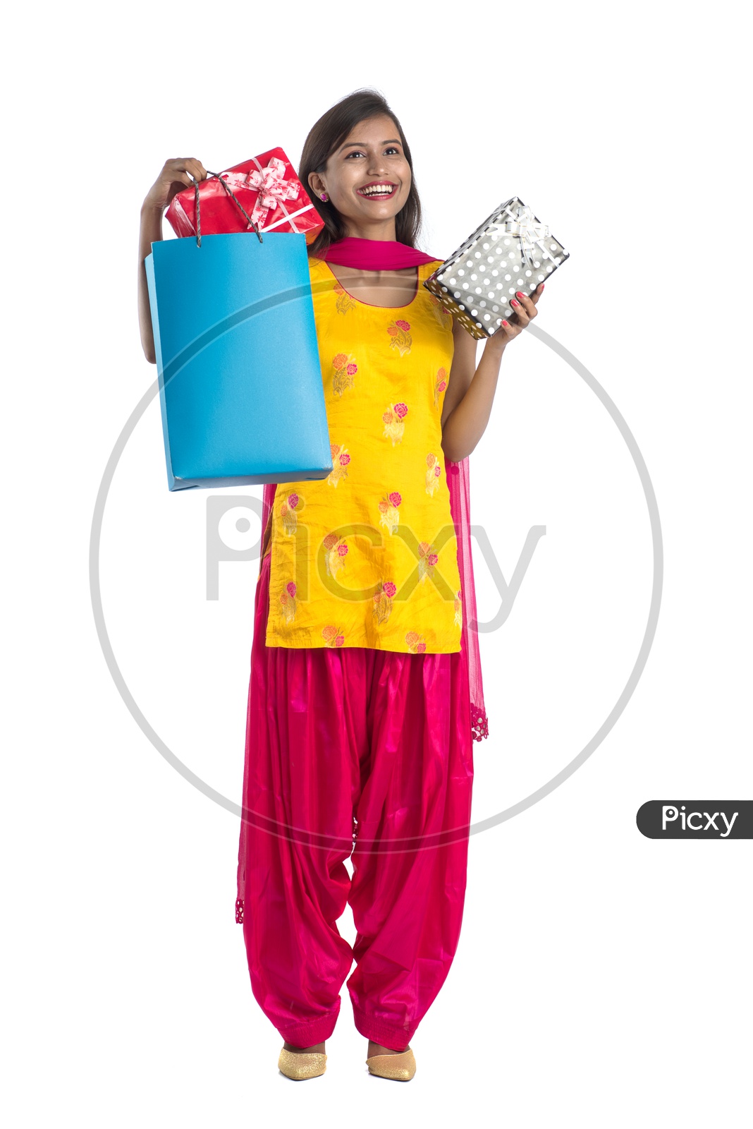 Young Indian Woman Or Girl Happily Smiling With Shopping Bags Gifts  On an Isolated White background