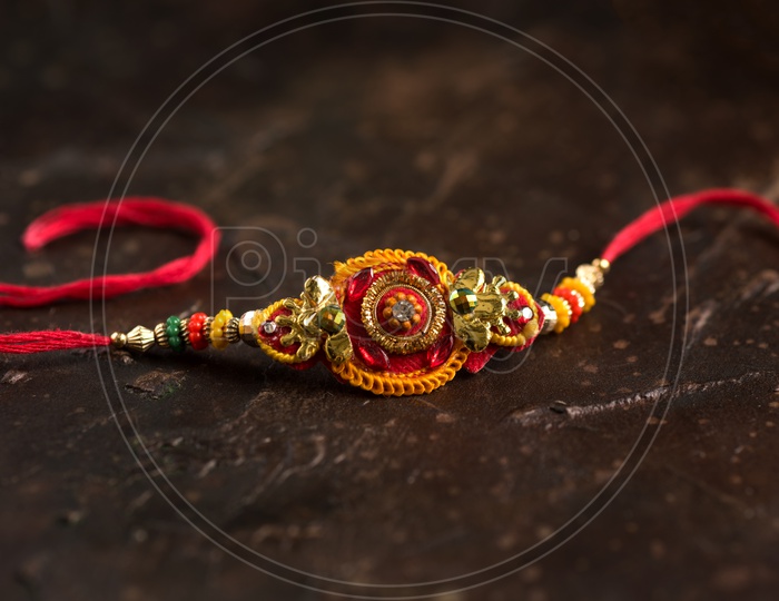 Elegant Rakhi  On an Textures Background For Raksha Bandhan Festival