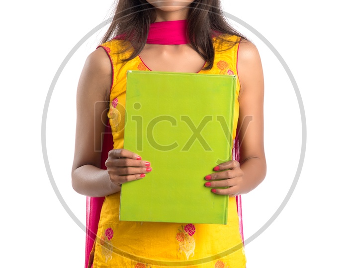 Young Indian Girl Student Holding Books In Hand And Posing On an Isolated White Background