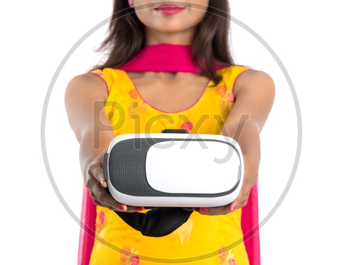 Young Indian Woman Or Girl Holding and Posing With a VR Headset Or Virtual reality Glasses On an Isolated White Background