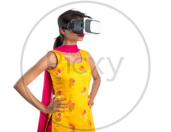 Young Woman Or Indian Woman Wearing  VR Headset or Virtual Reality Glasses On an Isolated white Background