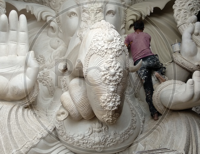 Ganesh idol making at Dhoolpet, A Man doing Finishing the Idol