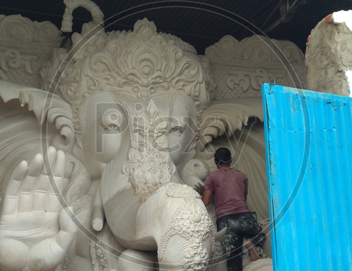Prepartion of Ganesh Idol for Ganesh Chathurthi. A man working on idol for Vinayaka Chaturthi
