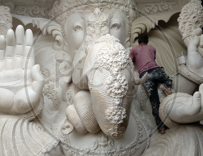 Prepartion of Ganesh Idol for Ganesh Chathurthi. A Man sat and Cleaning the Dust, Final Finshing