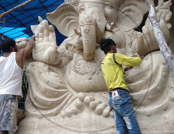 Ganesh Idol for Ganesh Chathurthi, A man Finished the Idol and Removing all dust. Preparation of Ganesh Idol