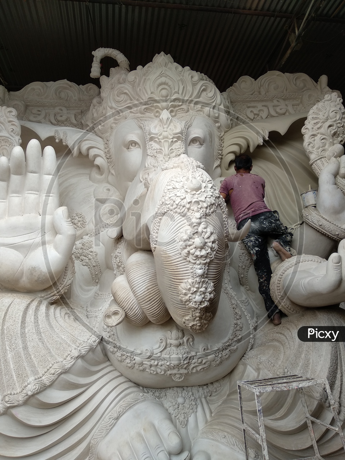 Prepartion of Ganesh Idol for Ganesh Chathurthi. A Man sat and Cleaning the Dust, Final Finshing