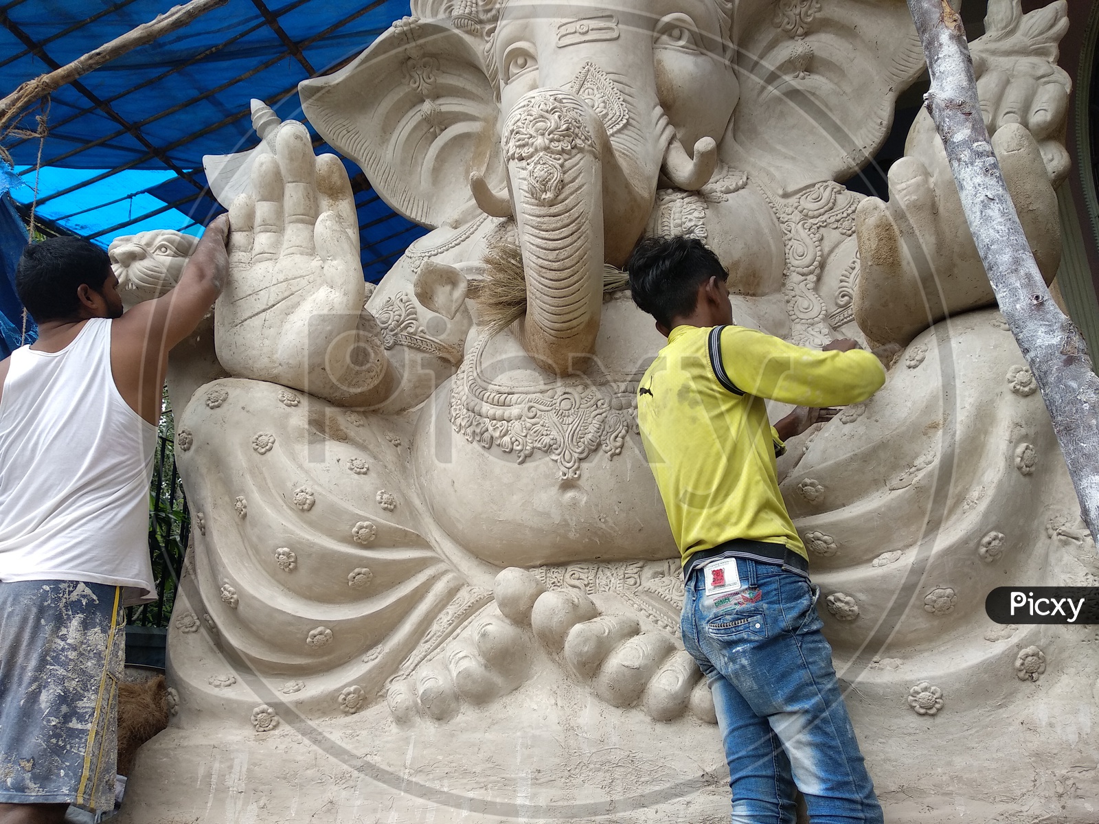 Ganesh Idol for Ganesh Chathurthi, A man Finished the Idol and Removing all dust. Preparation of Ganesh Idol