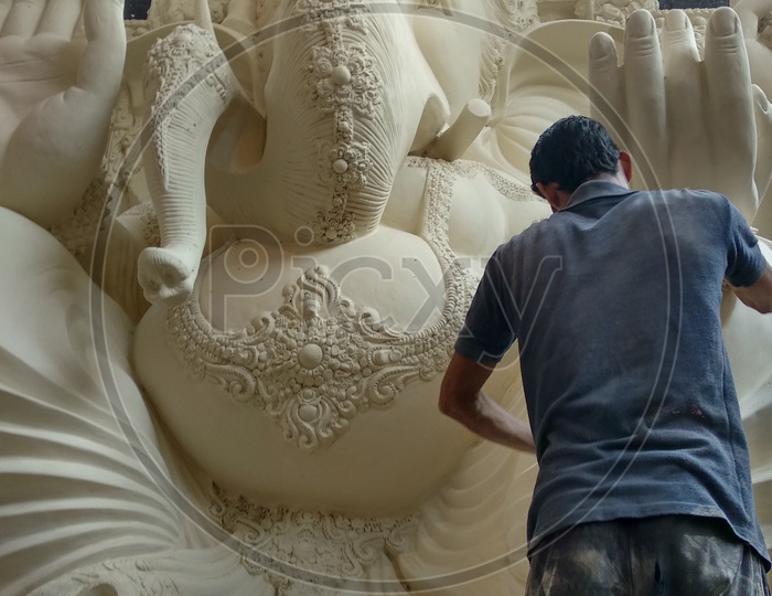 Prepartion of Ganesh Idol for Ganesh Chathurthi. A man working on Idol for Vinayaka Chathurthi.