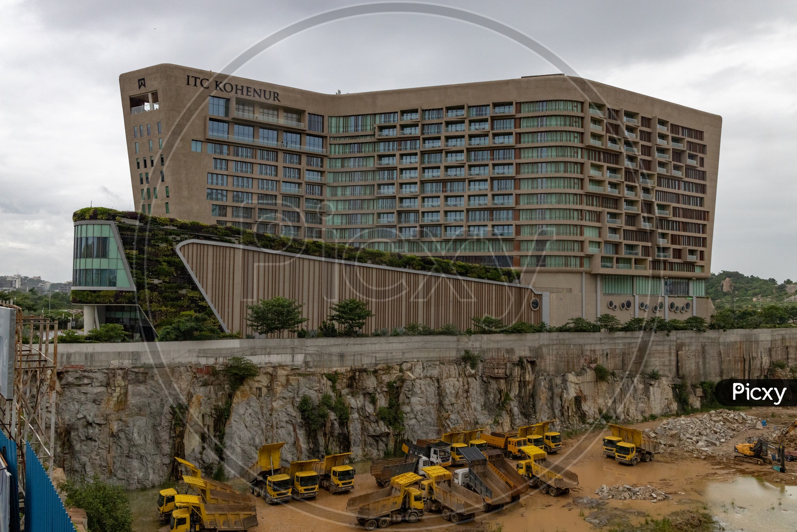 A View Of ITC Kohenur , A Luxury  Collections of Hotels in Hyderabad With Construction Trucks Or Trippers at Besides Construction Site