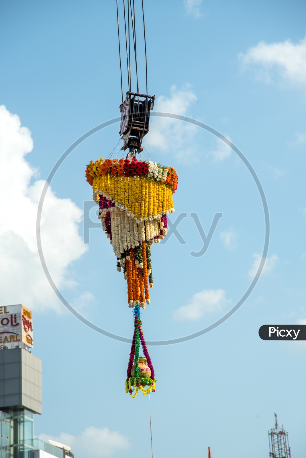 Dahi Handi Or Vutti  Hanging  For Gokul Or Sri Krishna Astami Festival With Pot Filled With Curd And Decorated With Flowers