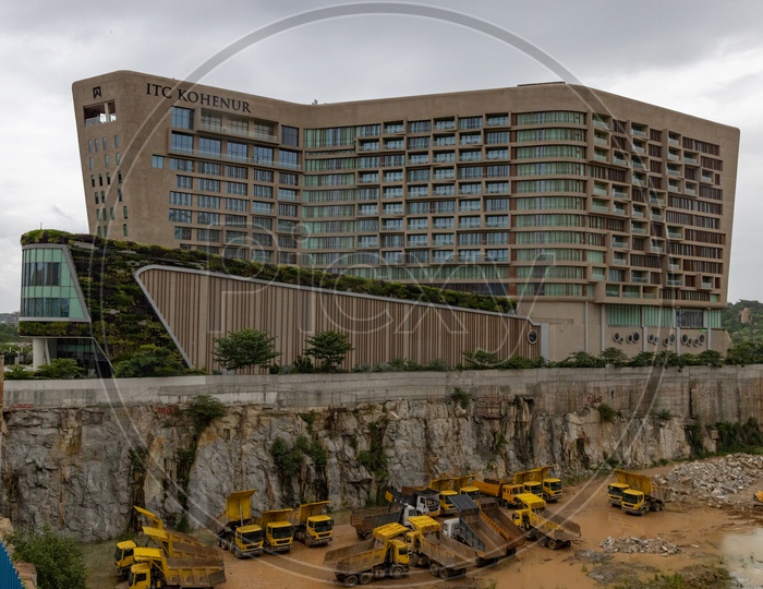 A View Of ITC Kohenur , A Luxury  Collections of Hotels in Hyderabad With Construction Trucks Or Trippers at Besides Construction Site