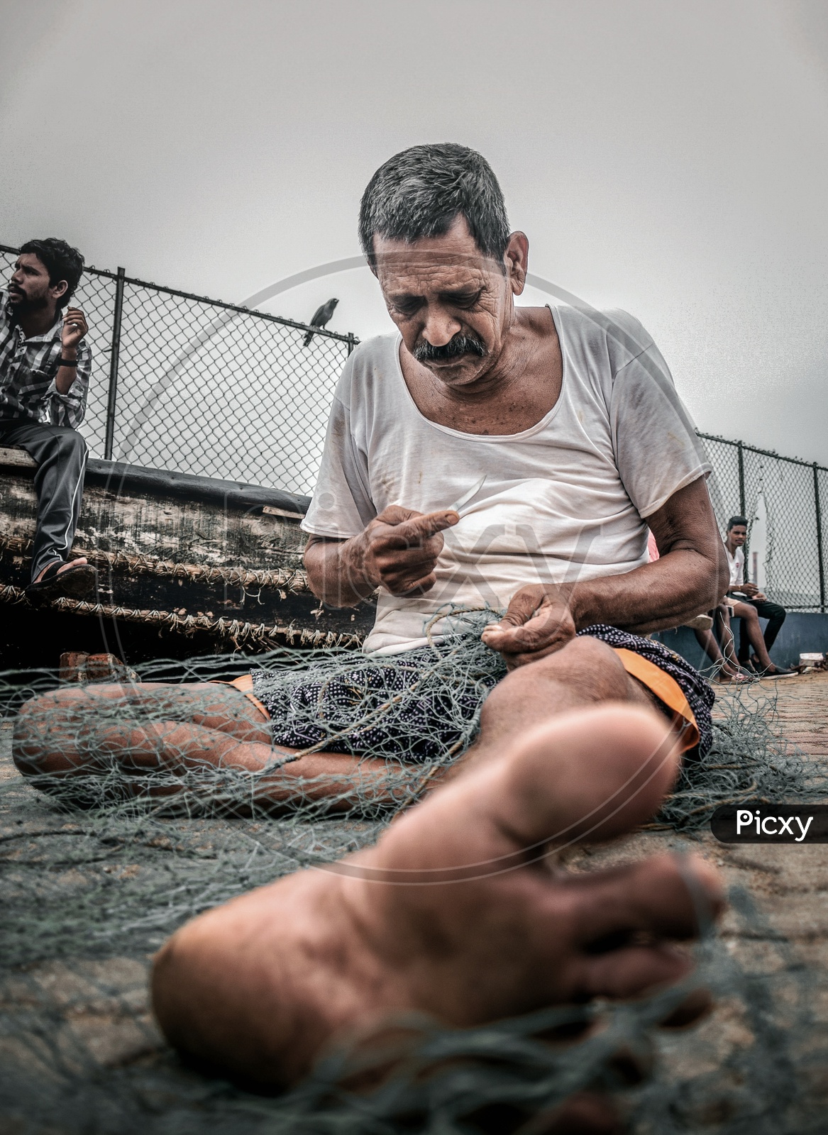 A fisherman Gear Knotting Fyke net