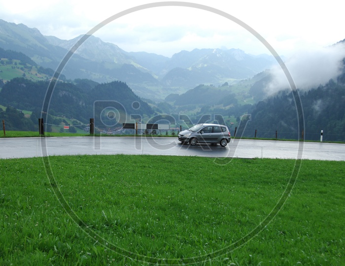 Cars On the Green Swiss Alps
