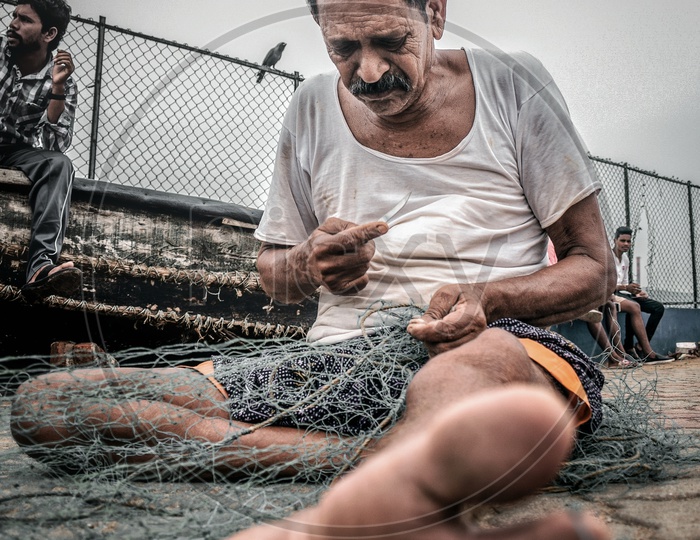 A fisherman Gear Knotting Fyke net