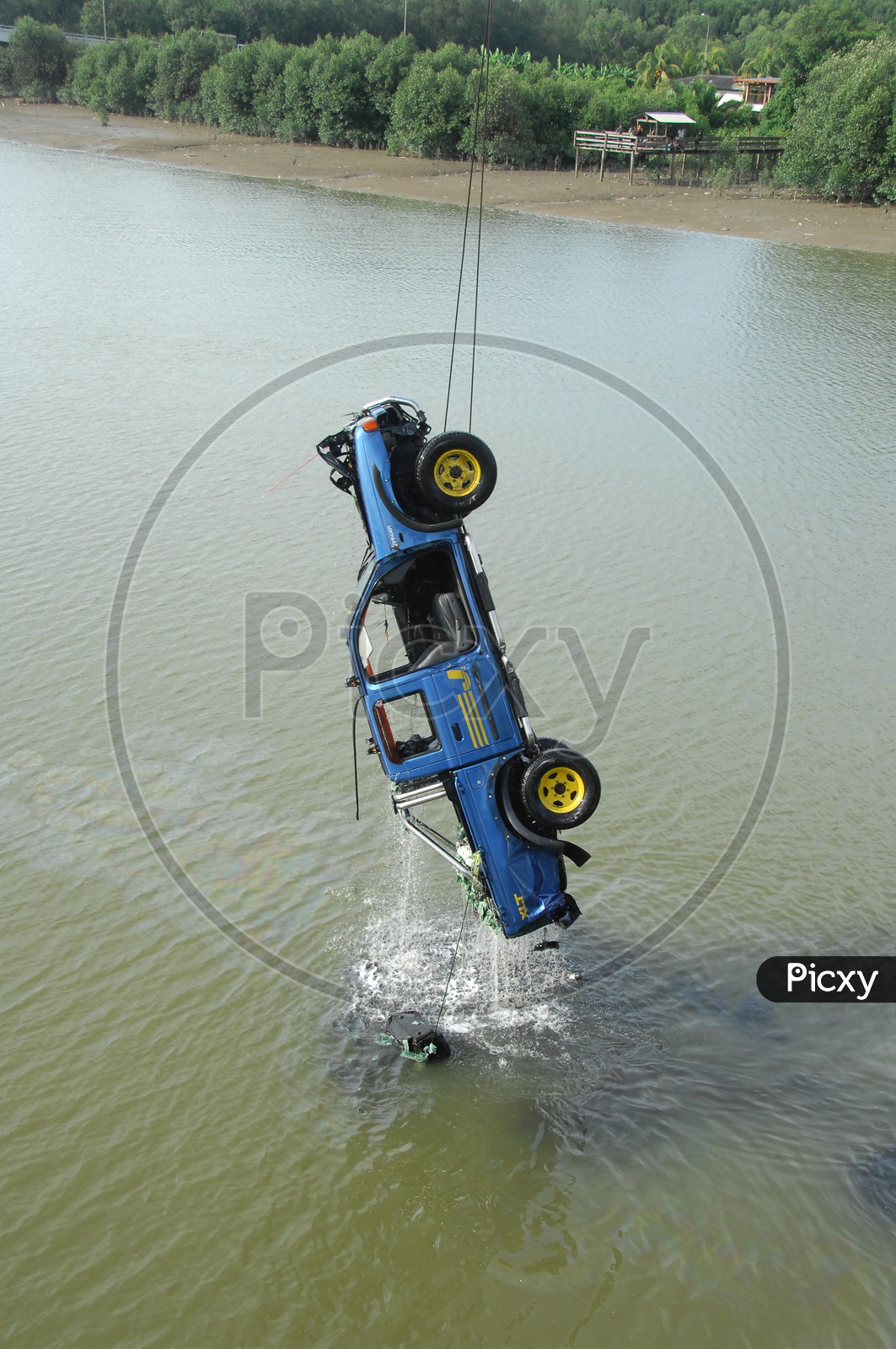 Crane pulling car out of  water