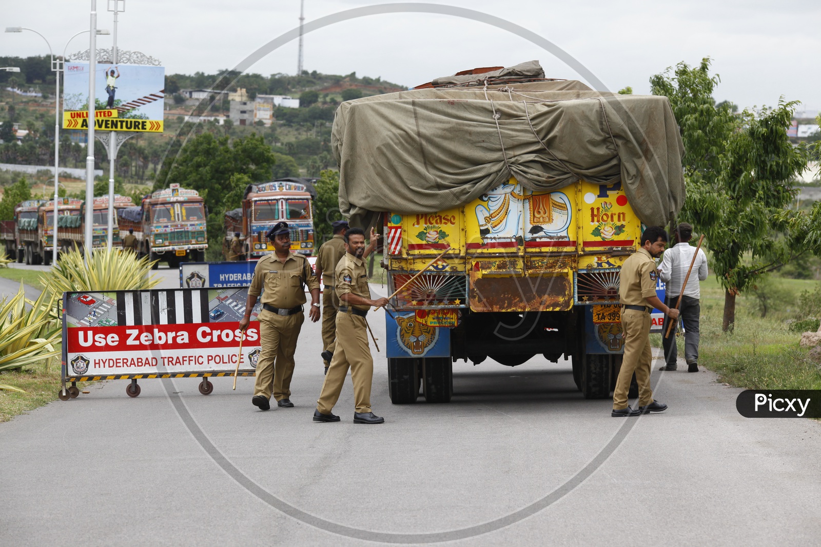 Police Man Checking Trucks lorries with Barricades at Highway Roads