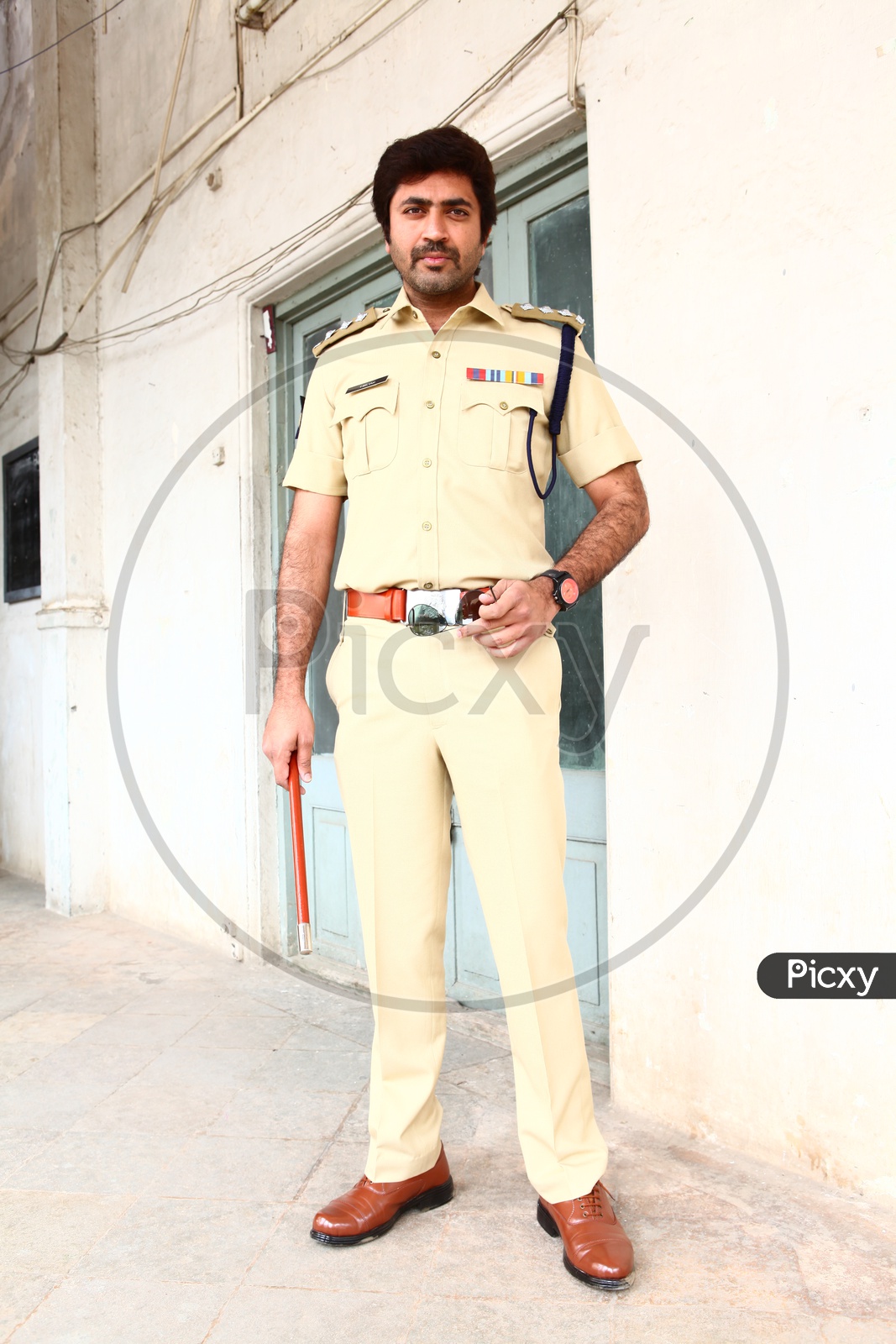 young Indian Man Wearing Police Uniform And Posing