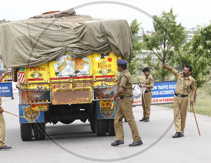 Police Man Checking Trucks lorries with Barricades at Highway Roads