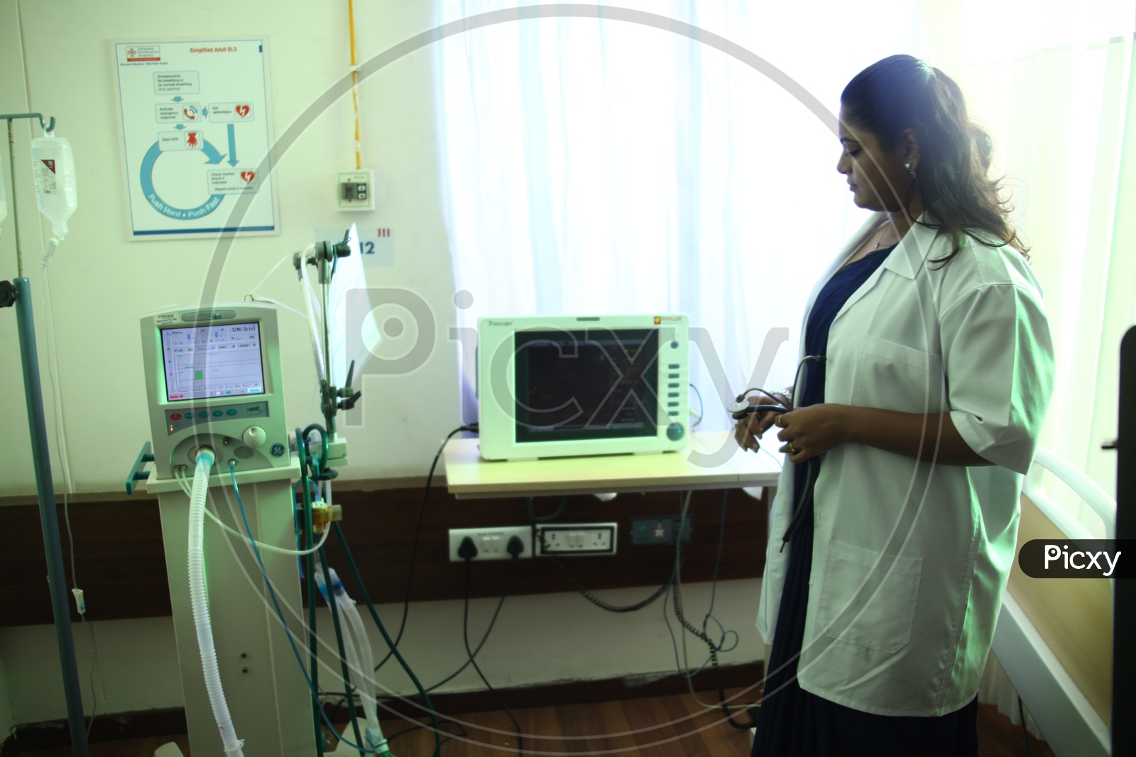 Lady Doctor Checking The Monitor In a Hospital Room