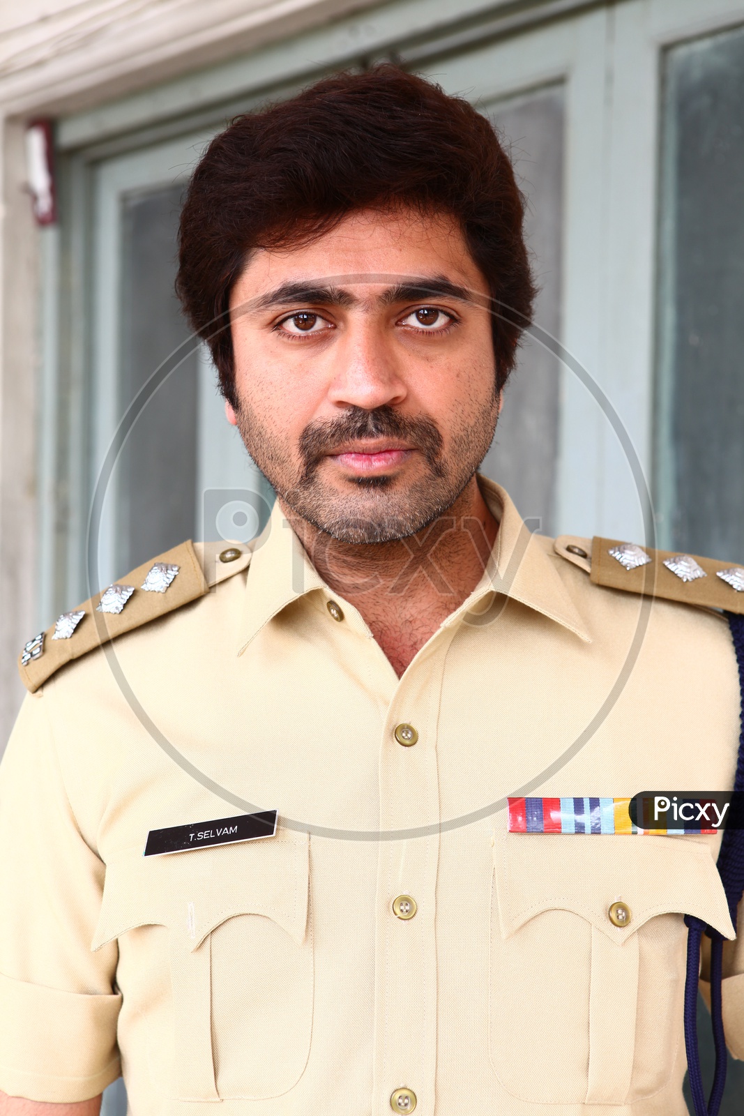 Image of young Indian Man Wearing Police Uniform And Posing-DC063105-Picxy