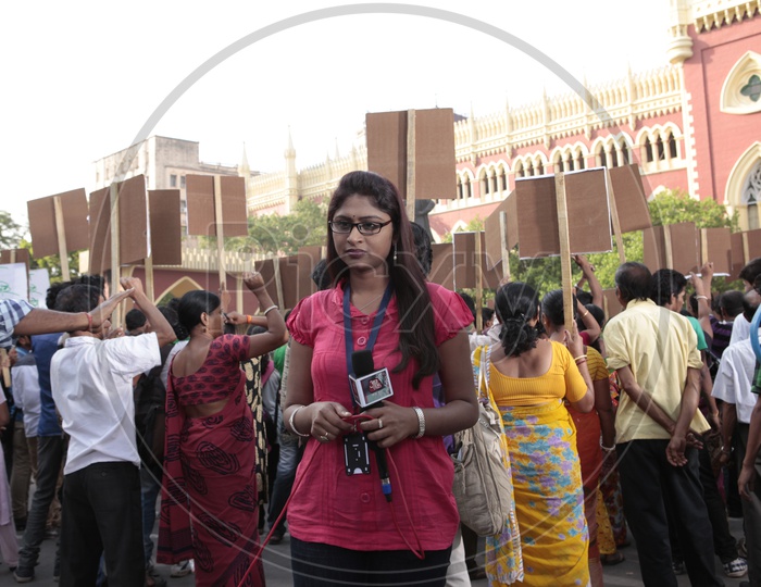 TV Reporter Or News Media Or Lady Reporter Reporting  From a Protest