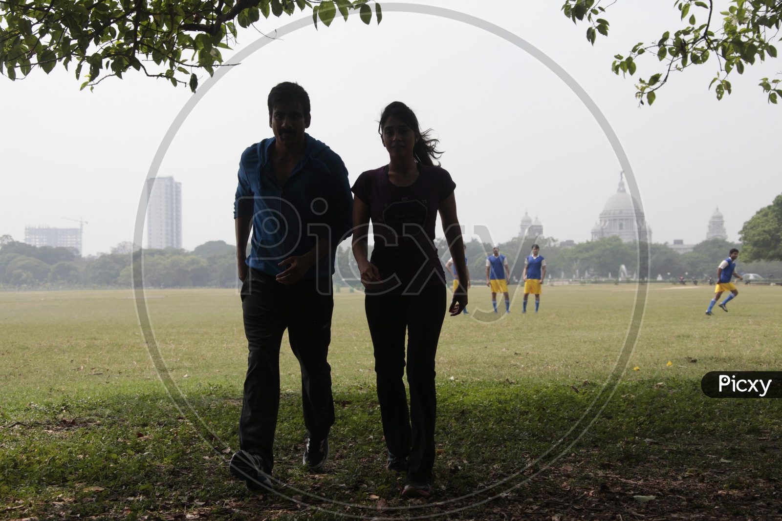 Silhouette Of a Couple Walking In a Football Ground