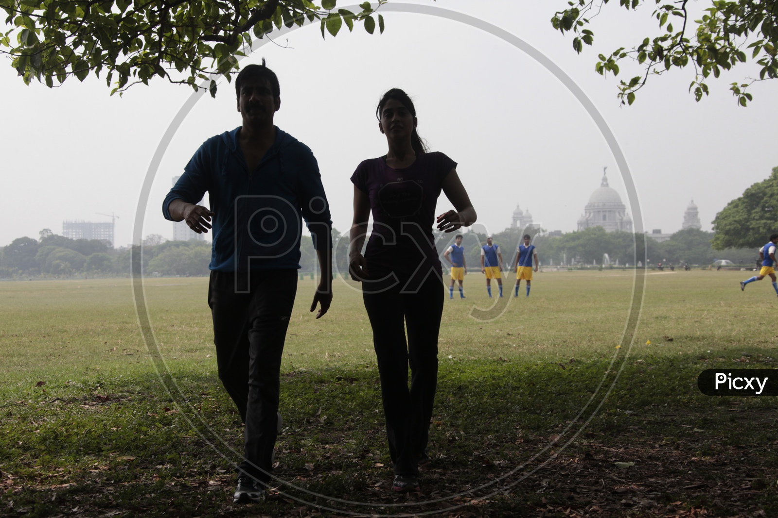 Silhouette Of a Couple Walking In a Football Ground