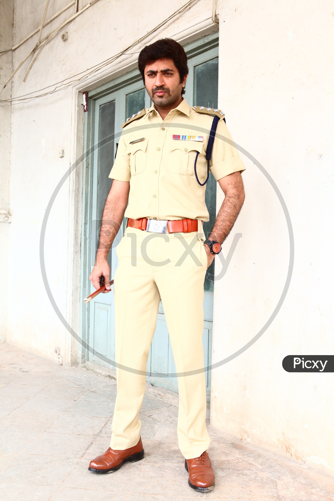 young Indian Man Wearing Police Uniform And Posing