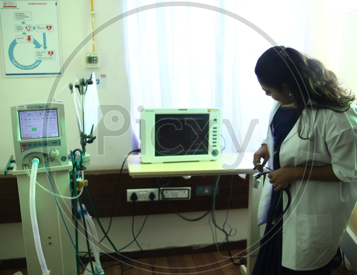 Lady Doctor Checking The Monitor In a Hospital Room