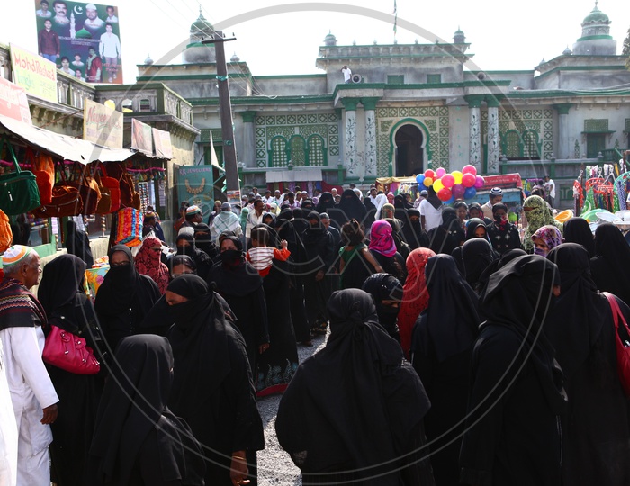 Muslim Woman Busily Shopping In a vendor Street