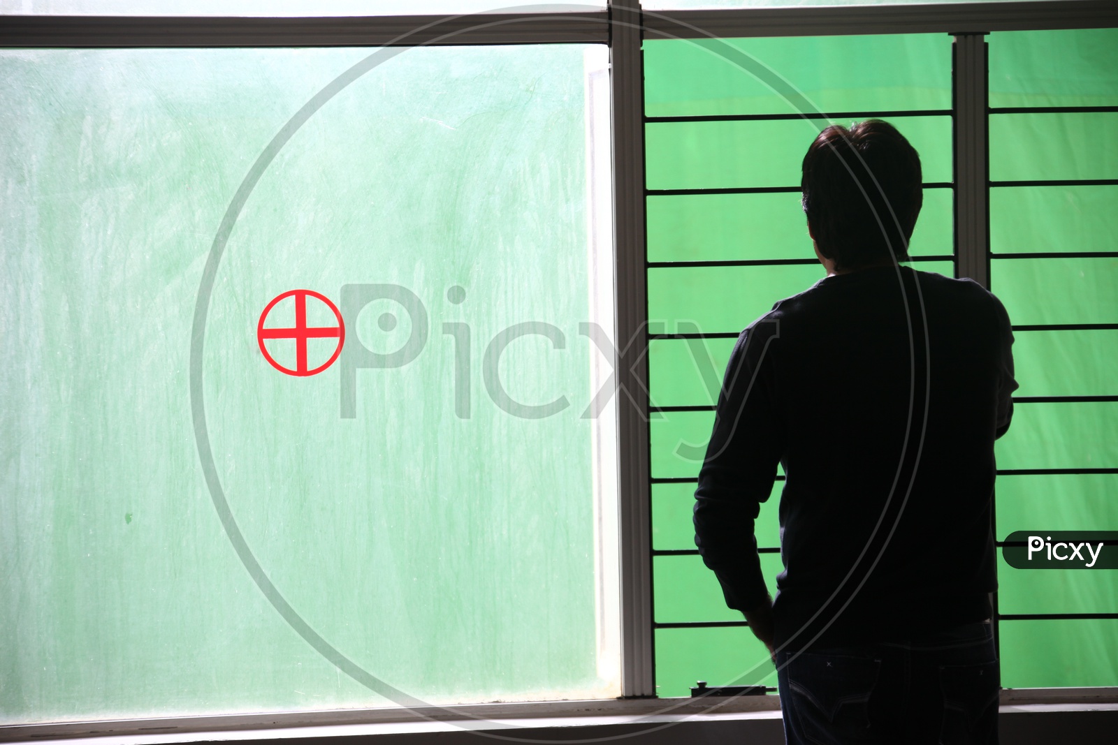 Silhouette Of a Man Standing at a Hospital Window