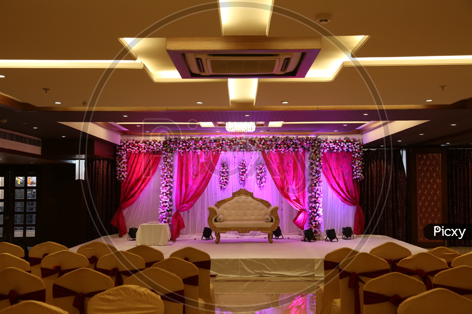 A Decorted stage in a functinoal hall with central A.C