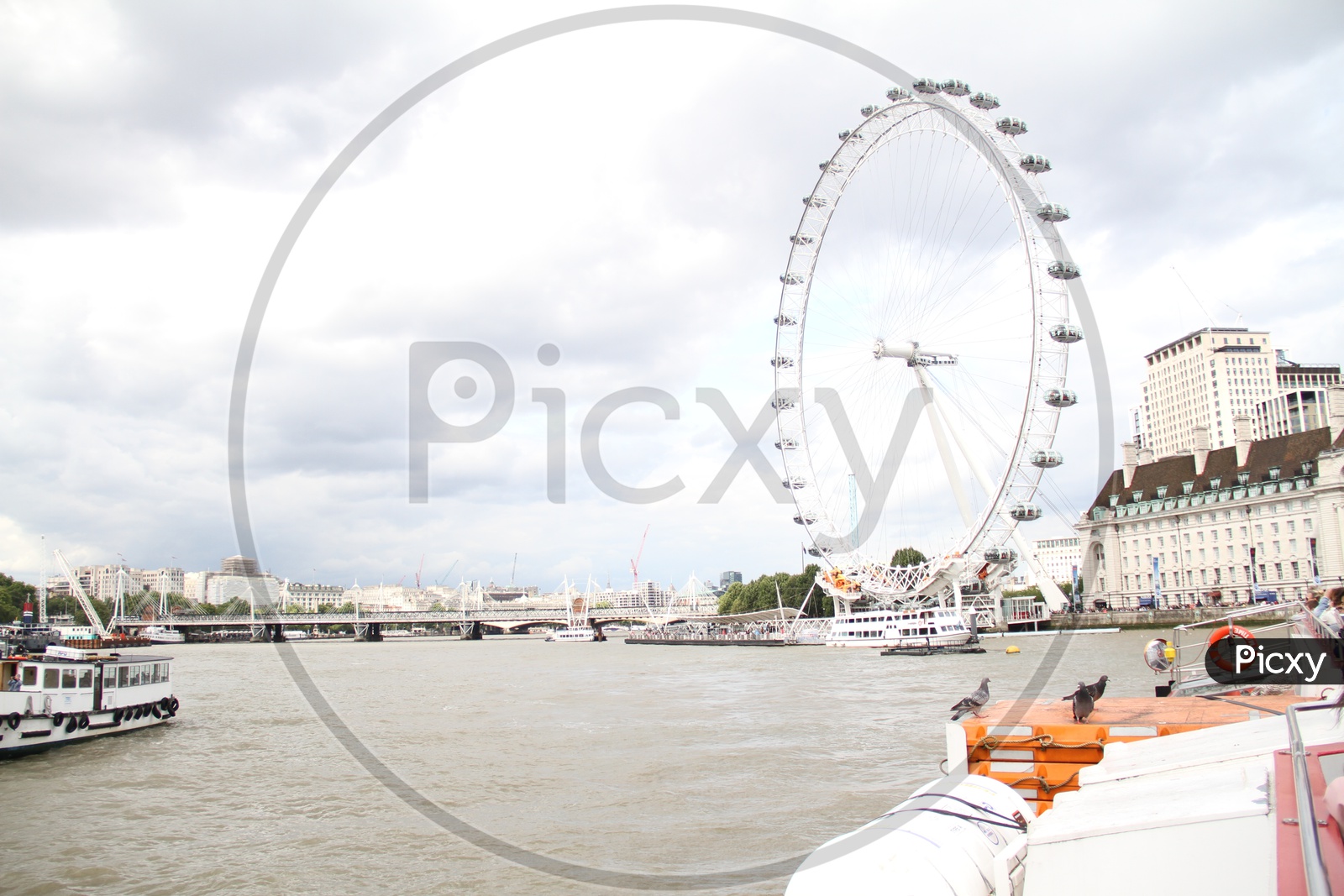London Eye and Tourist Boats on Thames River