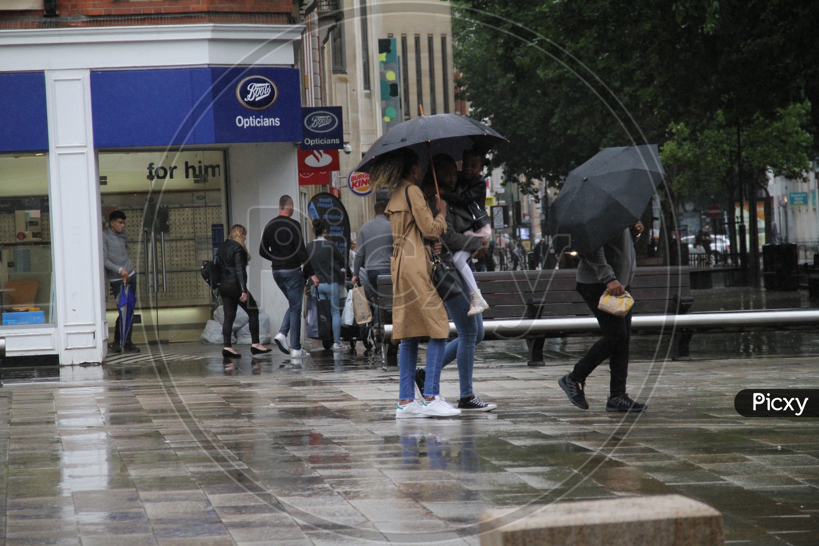People with Umbrellas walking in rain